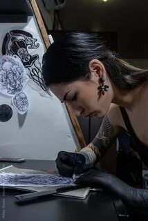 Female tattoo artist working at Tattoo Salon Female tattoo a