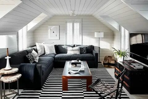 Shiplap attic family room is furnished with a deep seat blac
