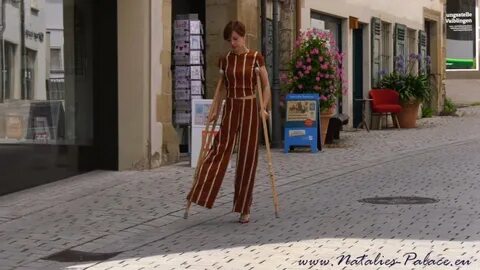 Amputee Nina walking with her empty pantleg hanging loose - 