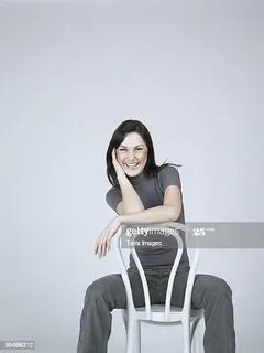 Woman Sitting Backwards On A Chair Photos and Premium High R