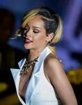 Rihanna shows huge cleavage and nipple piercing wearing whit