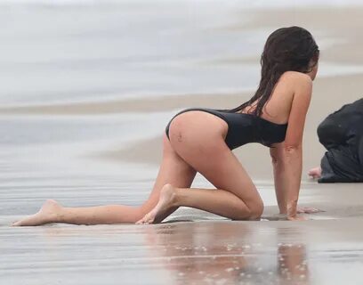 Kayla Swift in black swimsuit freezing on the beach during t