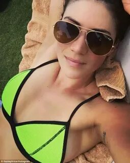 Stephanie Rice shows off her decolletage in a bright bikini 