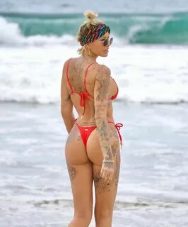 Tina Louise shows off her awesome body in a red thong bikini