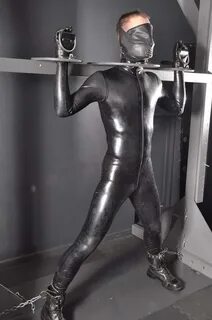 Standing bondage in rubber - Captured Heroes