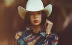 Ángela Aguilar wears long hair and a flirty cowboy outfit - 
