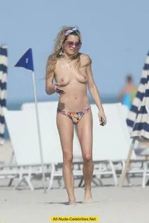 Chelsea Leyland topless on a beach in Miami
