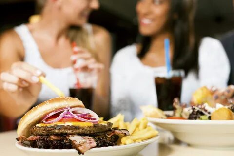 Two women eating hamburger and drinking soda - Smoky Mountai