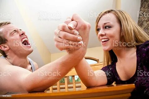 Woman Beating Strong Man In Friendly Arm Wrestling Competiti