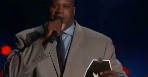 "Shaq holding the card containing the winner of Best eSports