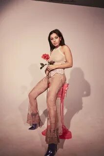 Charli XCX braless in a white mesh top and see-through pants