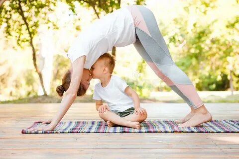 Young Woman Mother Practicing Yoga with Baby Stock Image - I