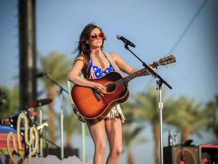 Kacey Musgraves performing in national colored bikini top an