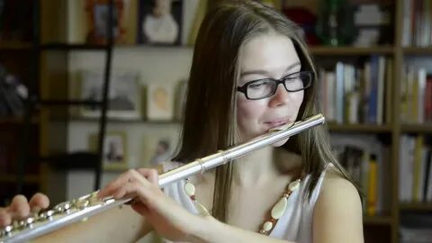 young girl playing flute living room Stok Videosu (%100 Teli