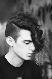 Alternative curly men's hairstyle with dyed tips Shaved side