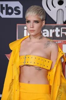 Halsey in yellow rainwear wears a belt instead of bra for iH