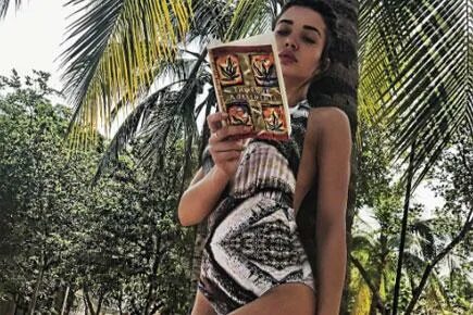Amy Jackson flaunts her hot bod in a swimsuit while reading 