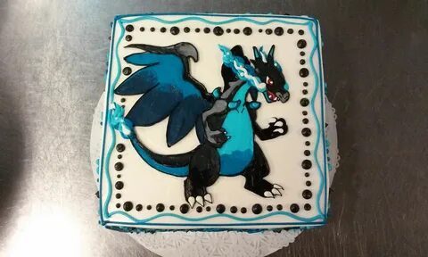 An eight inch square Pokemon cake with a Charizard illustrat