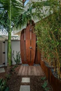 Incredible outdoor shower design, featuring a surfboard show