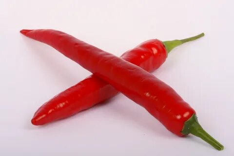 Two red peppers lie in the shape of a cross free image downl