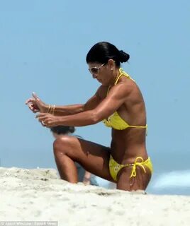 Teresa Giudice displays bronzed body in skimpy yellow bikini