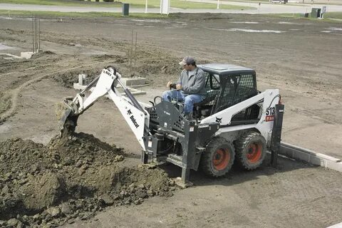 Bobcat Backhoe This backhoe attachment is being used to di. 