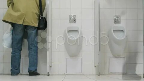 Men using urinals in supermarket toilet. Stock Footage - You