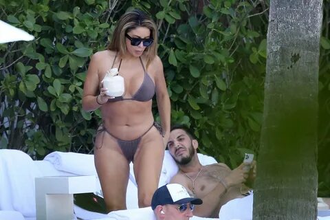 Busty Larsa Pippen Relaxes with a Mystery Man by the Pool in