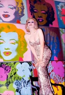 Candy Darling posing in front of Warhol paintings Candy darl