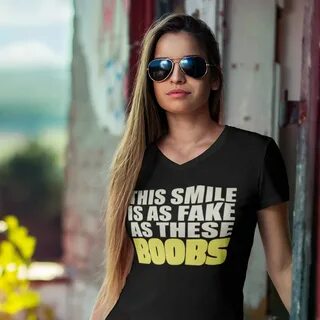 Woman wearing a 'this smile is as fake as these boobs' t-shirt.