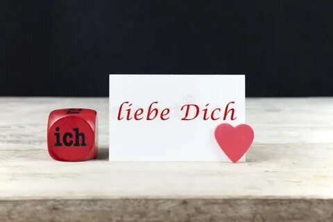 Valentine Greeting Card on Wooden Table with Text Ich Liebe 