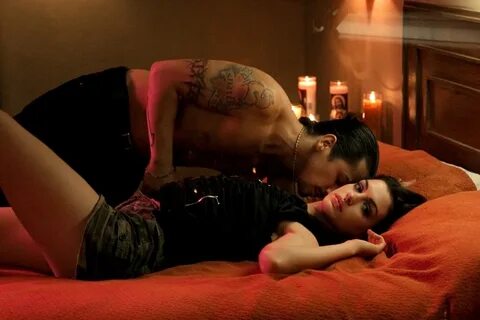 Freddy Rodriguez and Anne Hathaway lay in bed. 