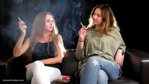 Two friends are smoking sitting on the sofa in this smoking 