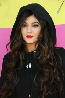 Kylie Jenner with red lips and long brown hair. I think she'