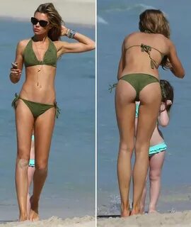 Abbey Clancy shows off her trim bikini figure as she jets of