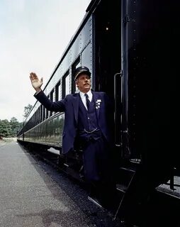 The conductor stands on the train steps free image download