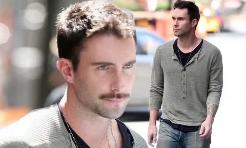 Adam Levine sports a thick moustache just moments after arri