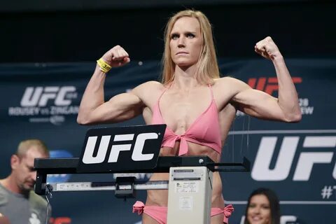 Holly Holm flexes during the UFC 184 weigh-ins at The Event Deck at L.A. Li...