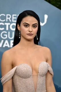 Camila Mendes braless in a plunging strapless nude gown at t