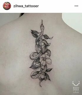 Linear snake wrapped around flower black line work tattoo id