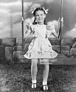 American child actress, Patti Brady, sitting on a swing, cir