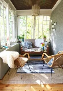 an eclectic and boho sunroom with wicker chairs and lamps, w