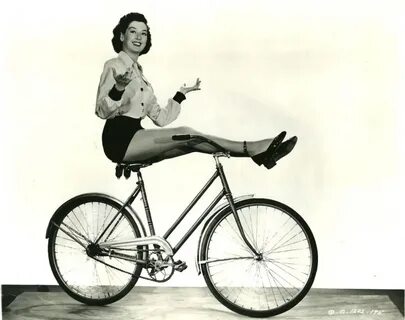 Rosalind Russell rides a bike - hands free, feet free, effor