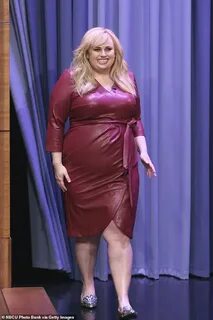 Rebel Wilson slips herself into a racy maroon leather dress 