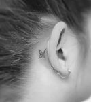 Small intricate butterfly tattoo behind the ear www.otziapp.