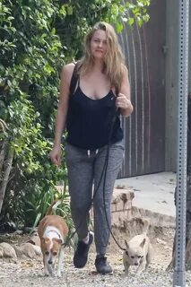 Alicia Silverstone braless in a sheer black tank top and swe