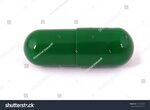Стоковая фотография 571310623: One Capsule Pill Green Color 