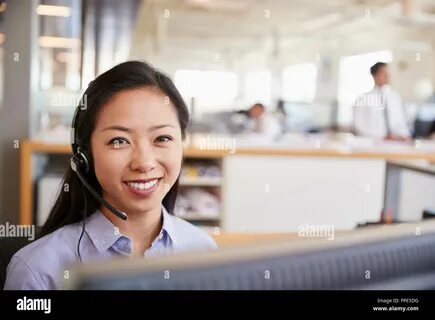 Chinese business woman smiling desk hi-res stock photography and images - Alamy
