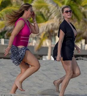 Bikini-clad Sandra Lee, 55, laughs on the beach in Mexico wh