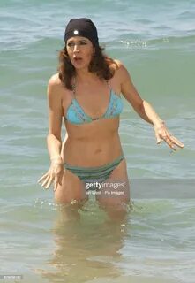 Actress Sean Young poses for photographers in the sea during a... News Phot...